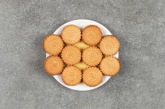 Delicious cookies filled with cream on white plate