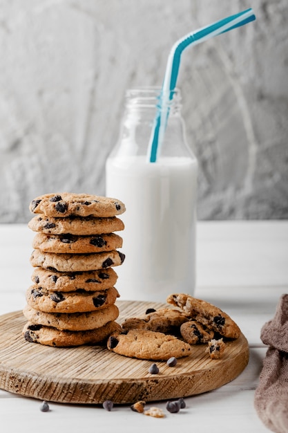 Delicious cookies next to jar with milk