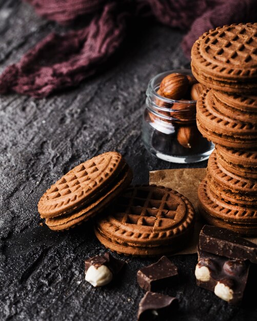 Delicious cookies next to jar with nuts