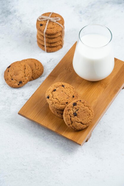 Delicious cookies with chocolate on a wooden cutting board.