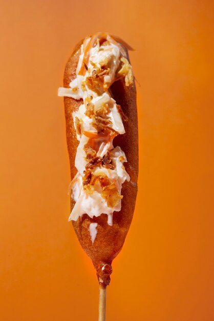 Delicious corn dog with orange background