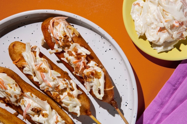 Delicious corn dogs on plate top view