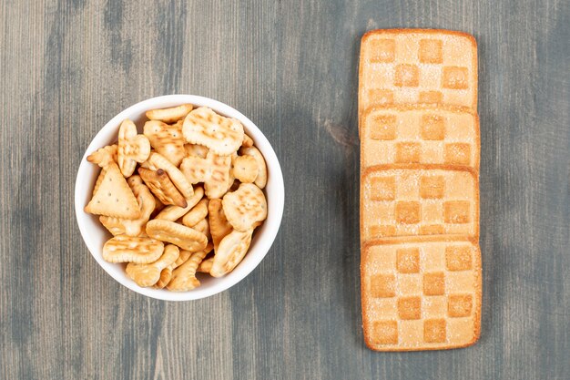 Delicious crackers and cookies on white plates