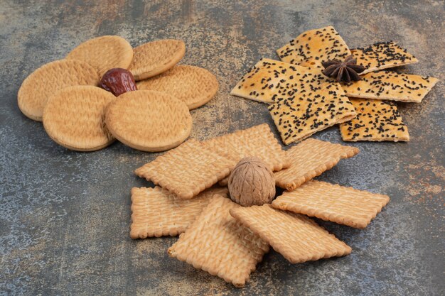 Delicious crackers with nut and star anise on marble background. High quality photo