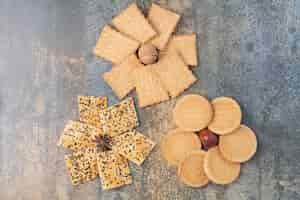 Free photo delicious crackers with nut and star anise on marble background. high quality photo