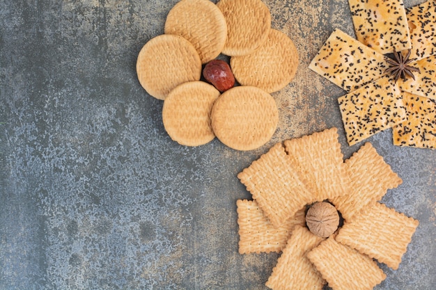 Delicious crackers with nut and star anise on marble background. High quality photo