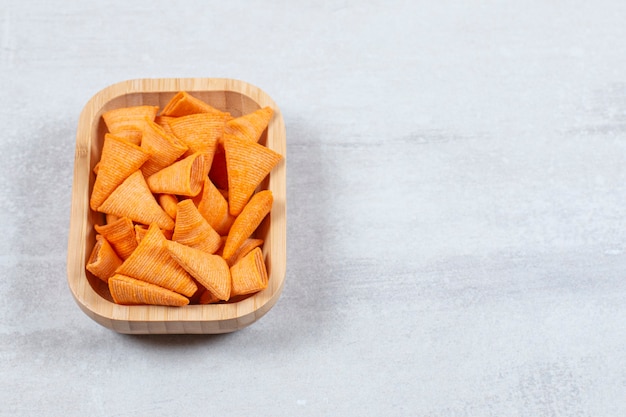 Delicious crispy crackers on wooden plate.