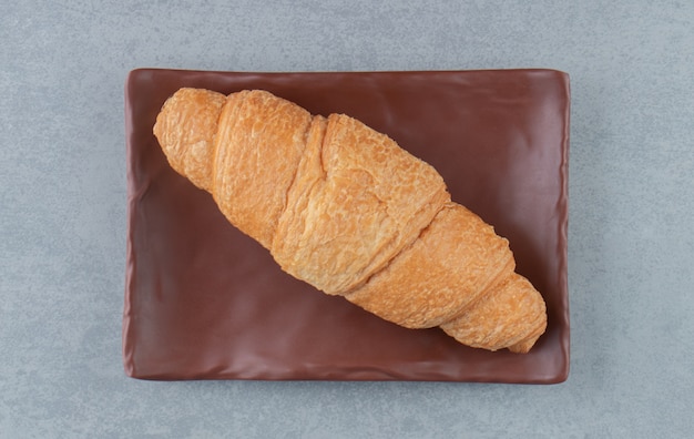 Delicious croissant on plate , on the marble background. High quality photo