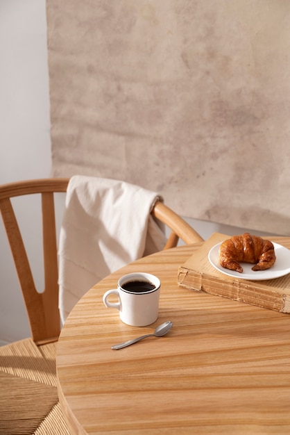 Delicious croissant on wooden table high angle