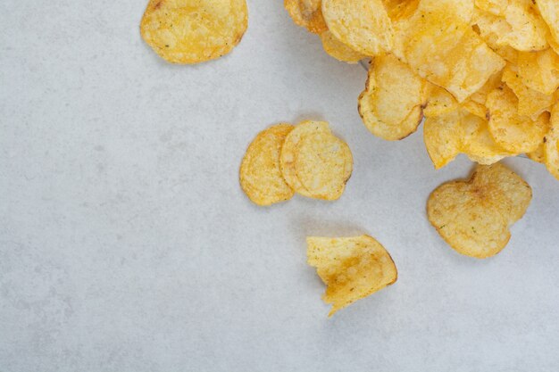 Delicious crunchy potato chips on white background. High quality photo