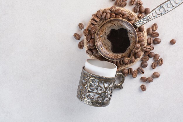 Delicious cup of aroma fresh cup of coffee with coffee beans . High quality photo