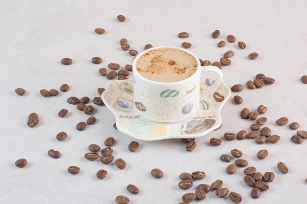 Delicious cup of aroma fresh cup of coffee with coffee beans . High quality photo