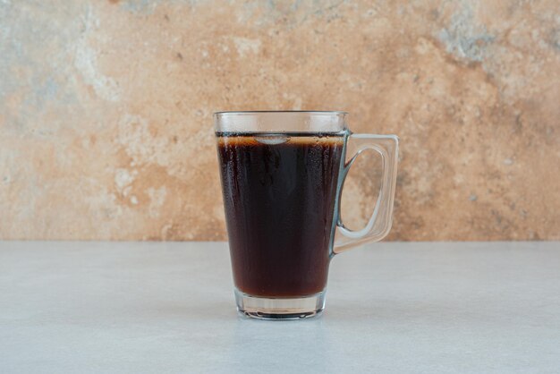 Delicious cup of tea on white table.