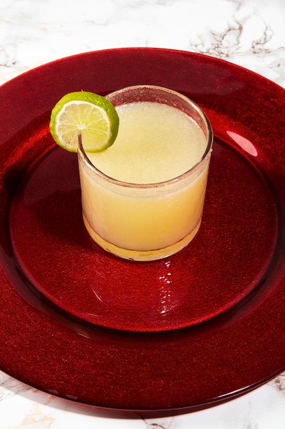 Delicious daiquiri cocktail glass with lime high angle