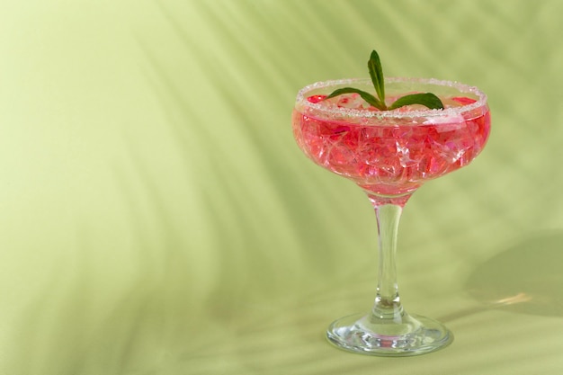 Delicious daiquiri with mint on green background