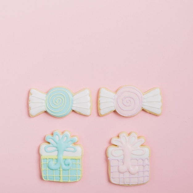 Free photo delicious decorated cookies on pink backdrop