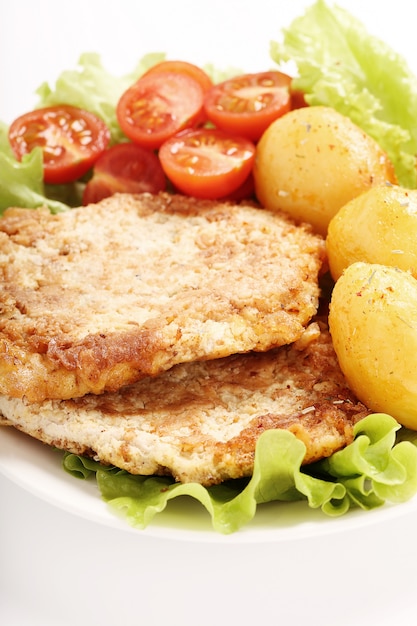 Delicious dinner with steaks, potatoes and salad