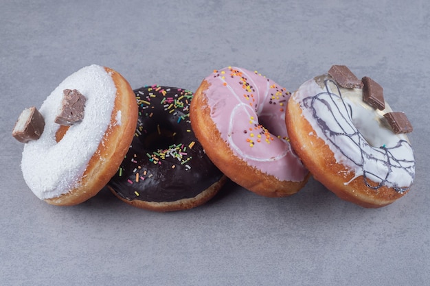 Delicious donuts bundled together on marble surface