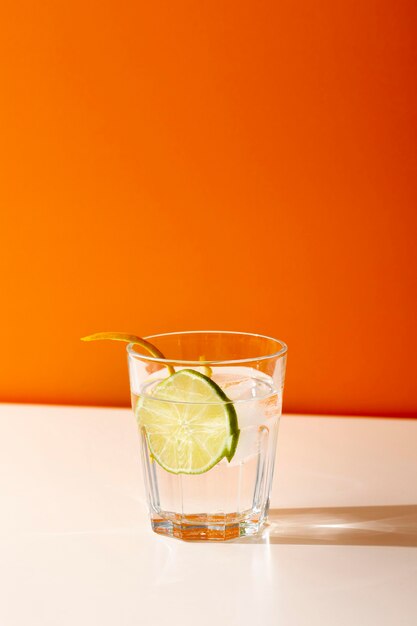 Delicious drink in glass with lime slice