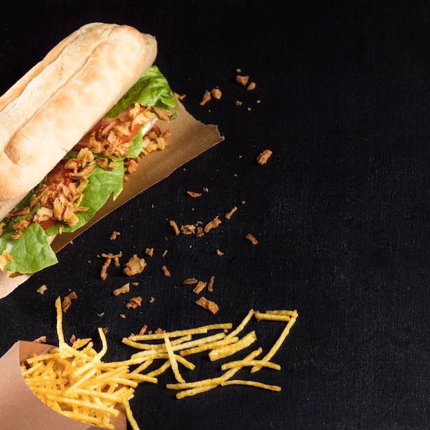 Delicious fast-food hot dog on baking paper flat lay