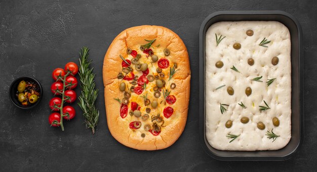 Delicious foccacia and ingredients flat lay