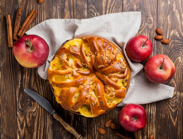 Delicious fresh apple pie on wooden background top view