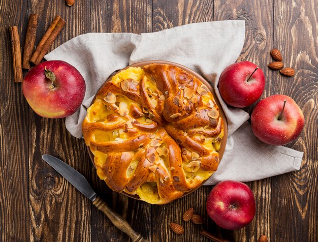 Delicious fresh apple pie on wooden background top view