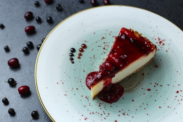 Delicious fresh cake with a red jam on a plate on the table
