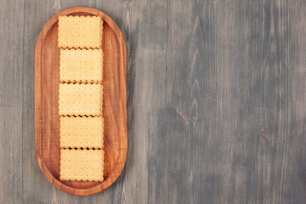 Delicious fresh crackers on a wooden board . High quality photo