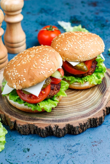 Delicious fresh homemade burgers on table