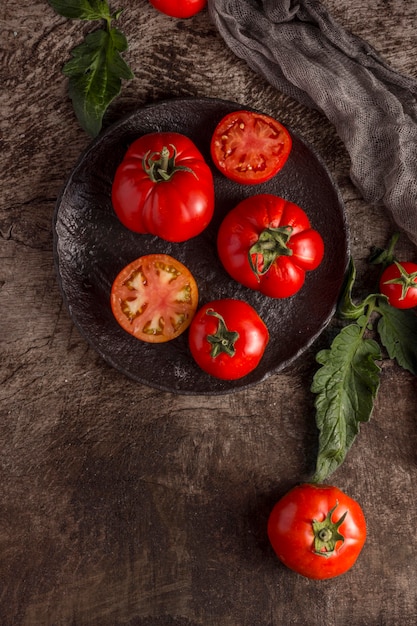 Delicious fresh tomatoes on plate flat lay