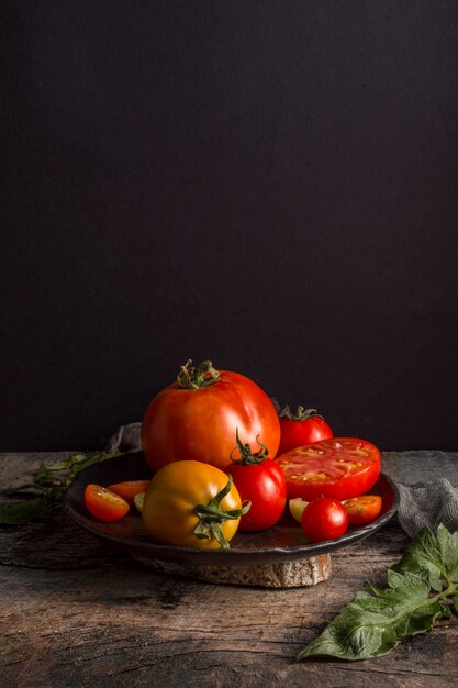 Delicious fresh tomatoes on plate high angle