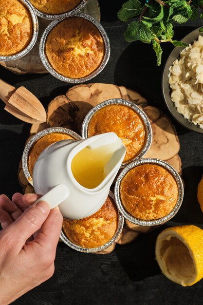 Delicious freshly baked lemon muffins topped with icing, top view