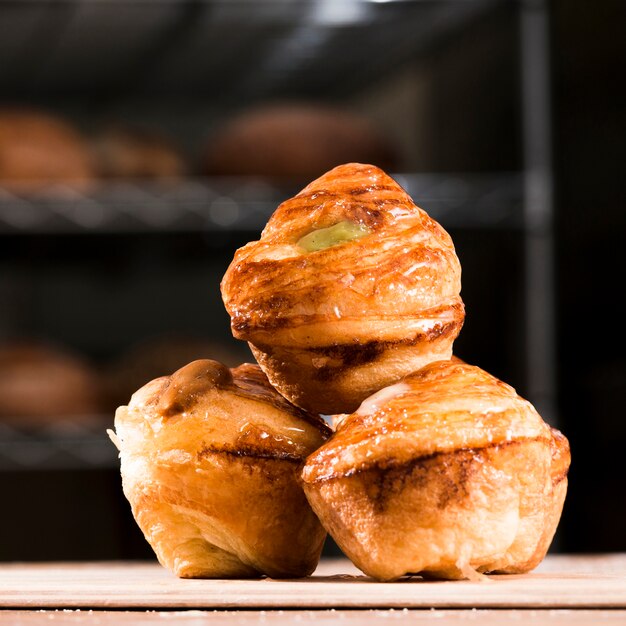 Delicious freshly baked sweet puff pastry on plank over the wooden table