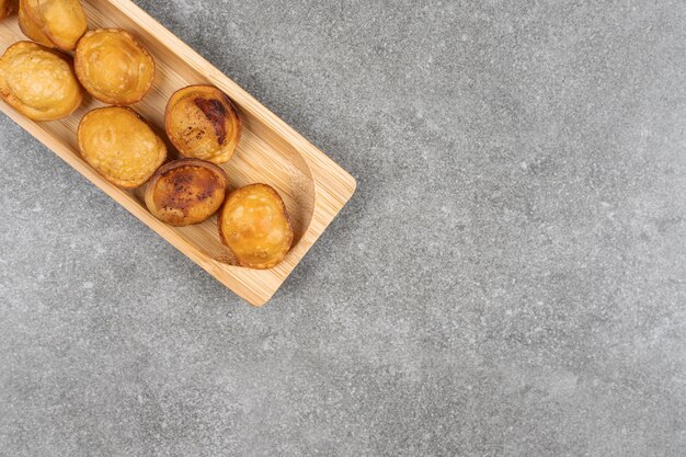 Delicious fried dumpling on wooden plate