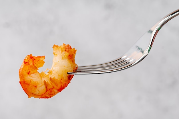 Delicious fried mussel on fork