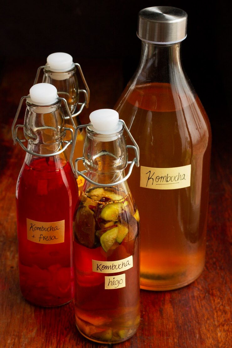 Free Photo delicious fruits kombucha bottles still life
