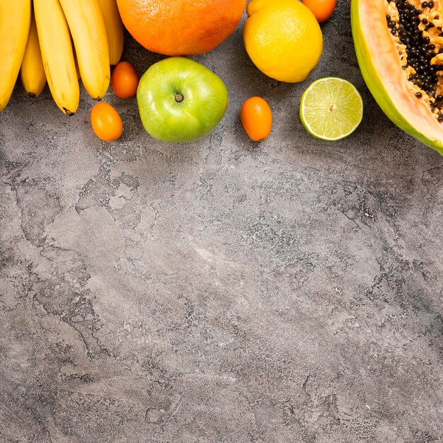 Delicious fruits on stucco background