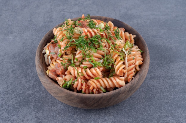 Free photo delicious fusilli pasta in wooden bowl.