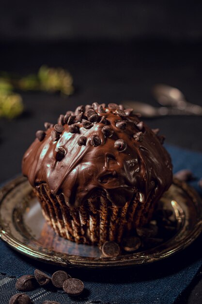 Delicious glazed cupcake with chocolate chips on top