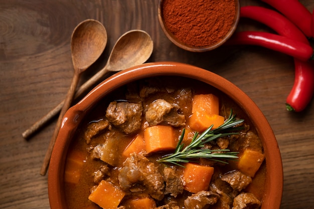 Delicious goulash stew on table