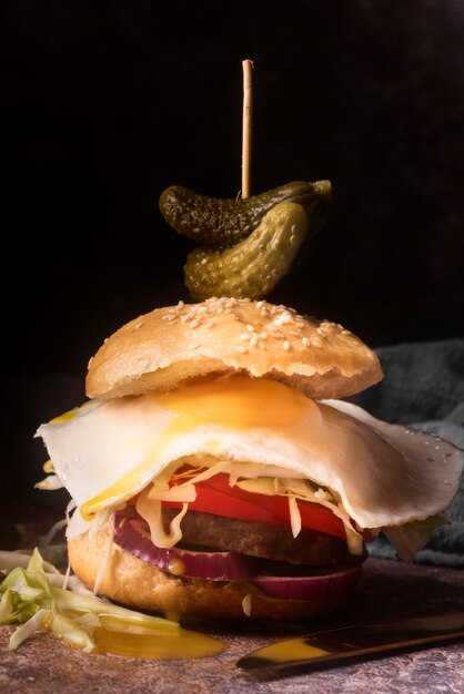 Delicious hamburger with fried egg close-up