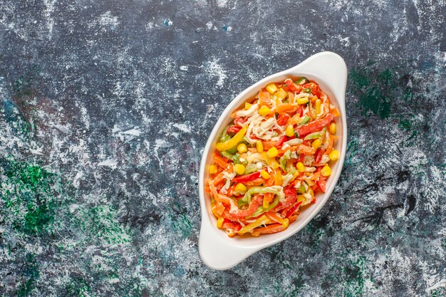 Delicious healthy bell pepper salad with chicken, top view