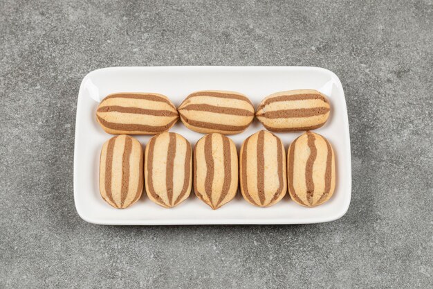 Delicious homemade biscuits on white square plate