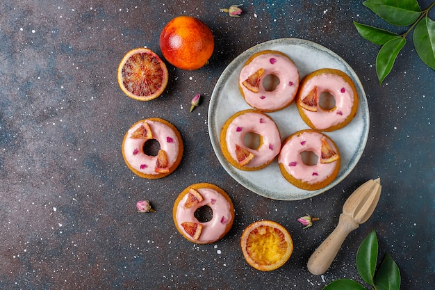 Free photo delicious homemade blood orange glaze donuts.