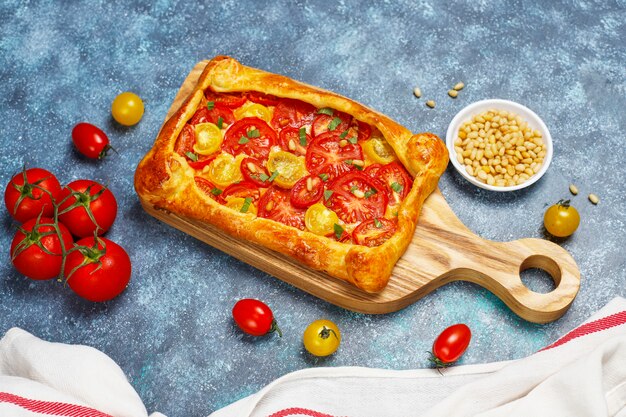 Delicious homemade rustic open pie ,galette with various tomatoes and pine nuts