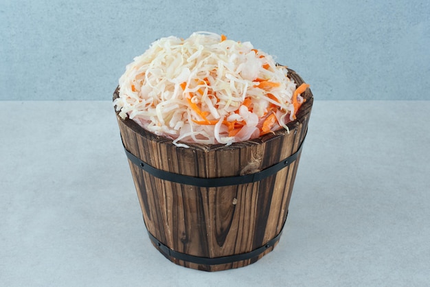 Delicious homemade sauerkraut in wooden bucket.