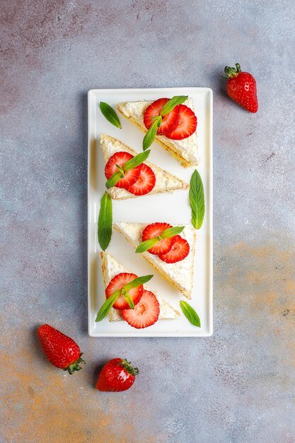 Delicious homemade strawberry cake slices with cream and fresh strawberries,top view