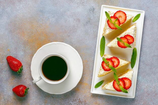 Delicious homemade strawberry cake slices with cream and fresh strawberries