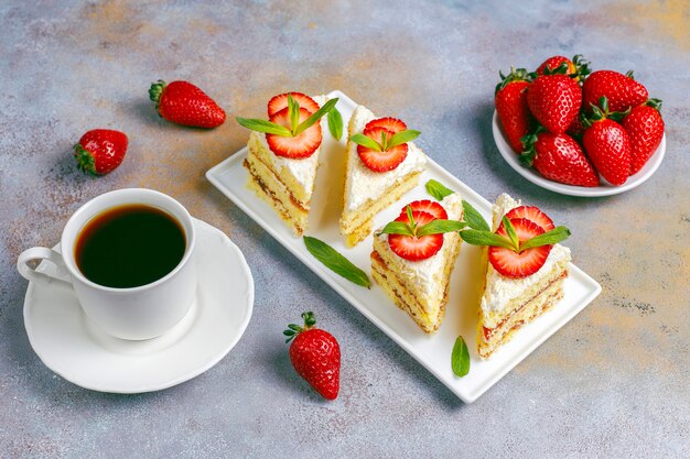 Delicious homemade strawberry cake slices with cream and fresh strawberries